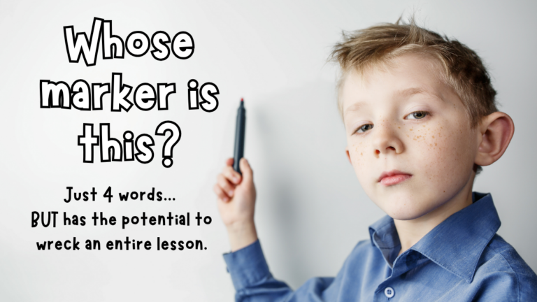 Elementary student holding a marker during a classroom lesson.